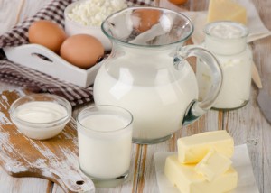 Milk products on a wooden table.
