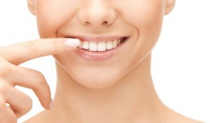 beautiful woman pointing to teeth